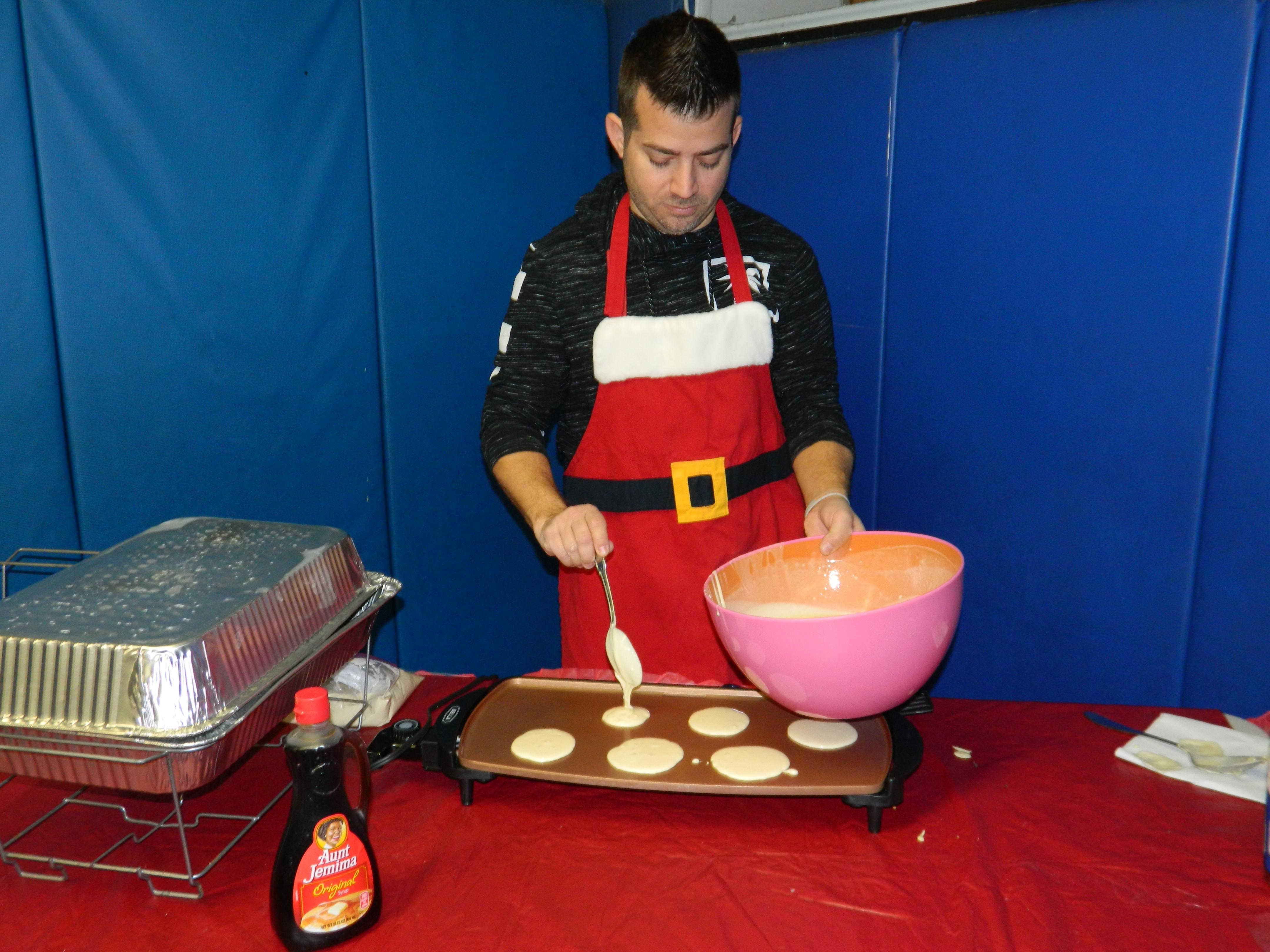 Mr. Dorsett making pancakes on the griddle