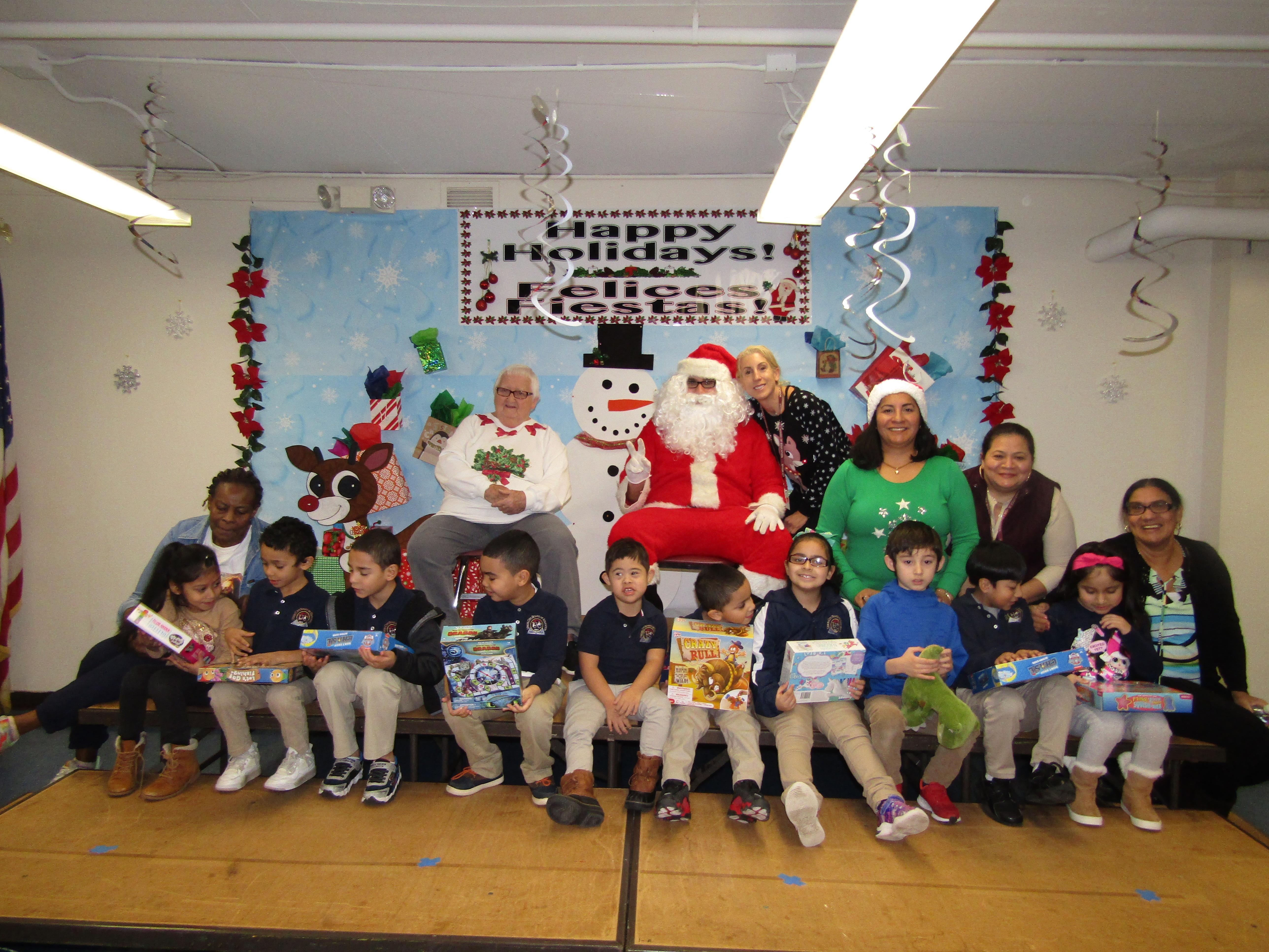 Ms. Marone's class with Santa holding onto their gifts