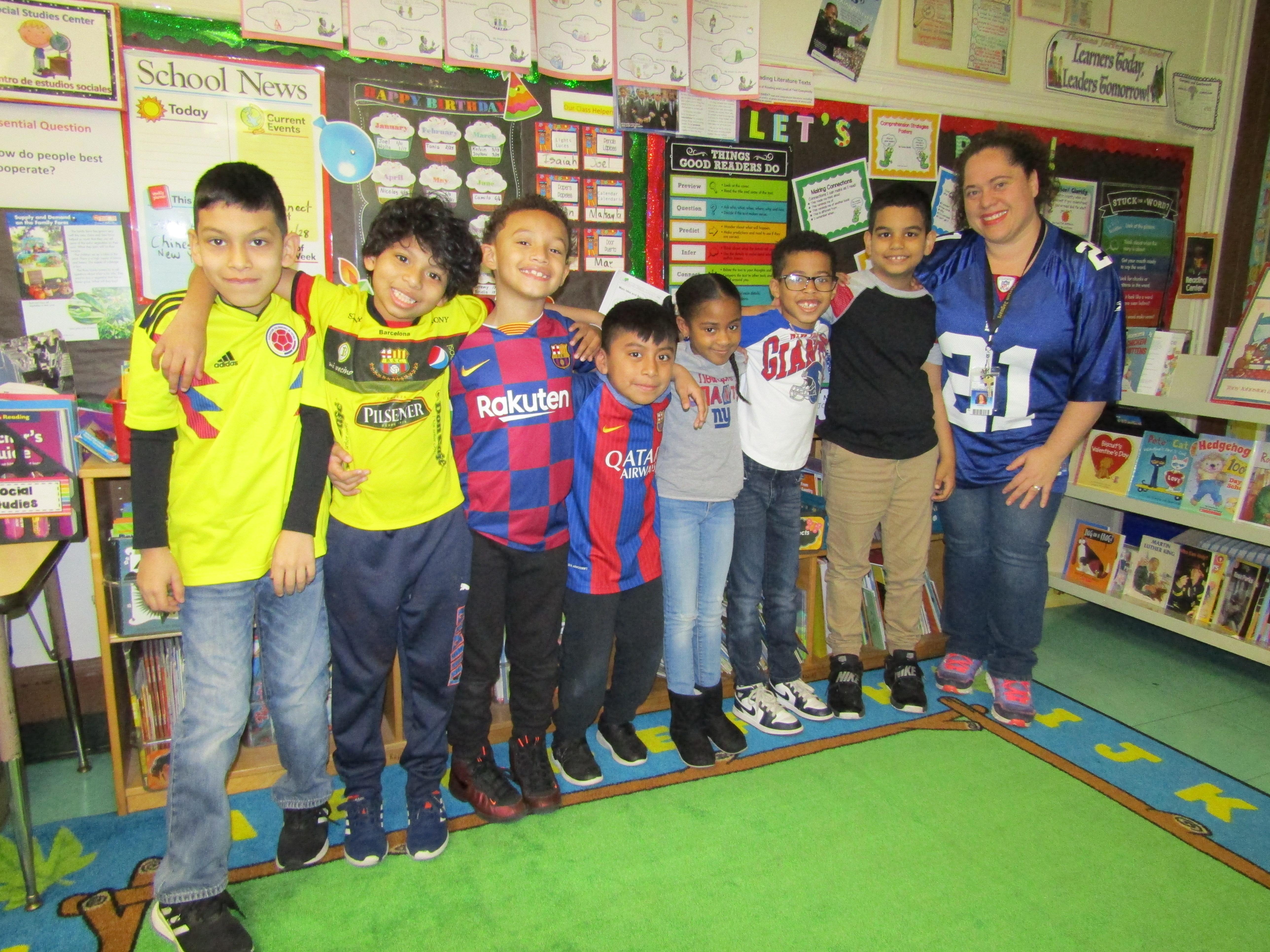 teacher with her students who are wearing sports jerseys