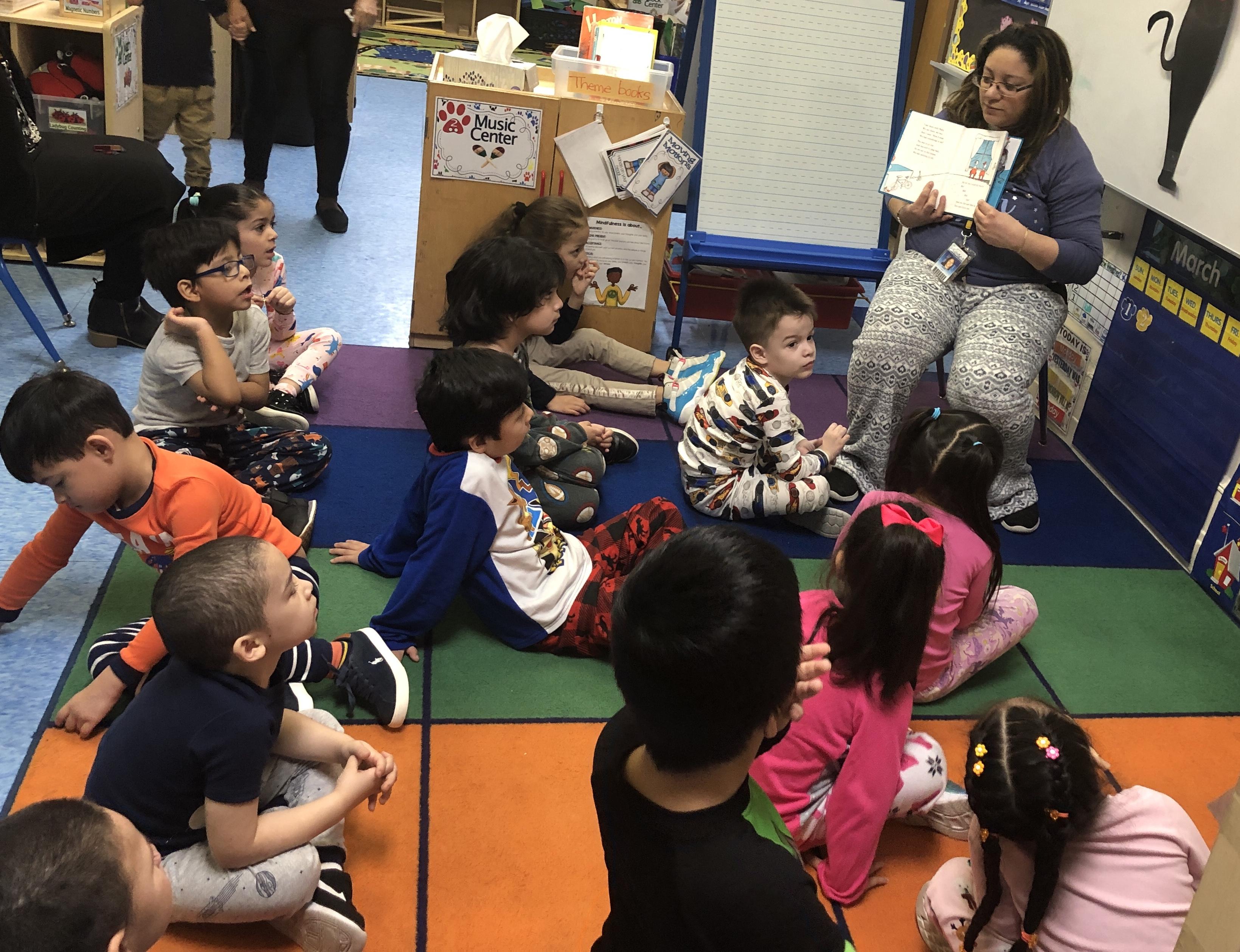 Mrs. Ortiz reading to her students wearing pjs