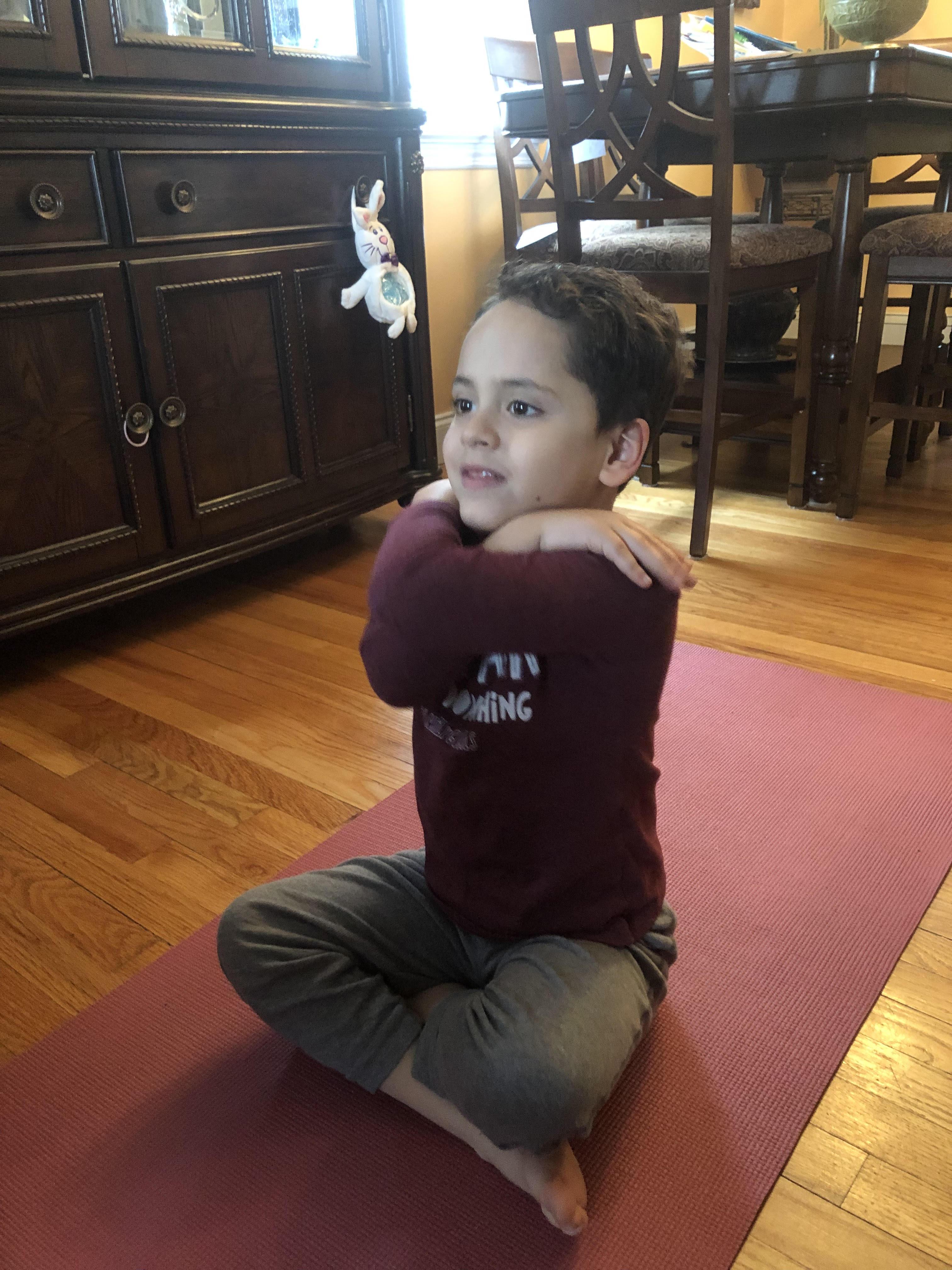 boy doing a yoga pose