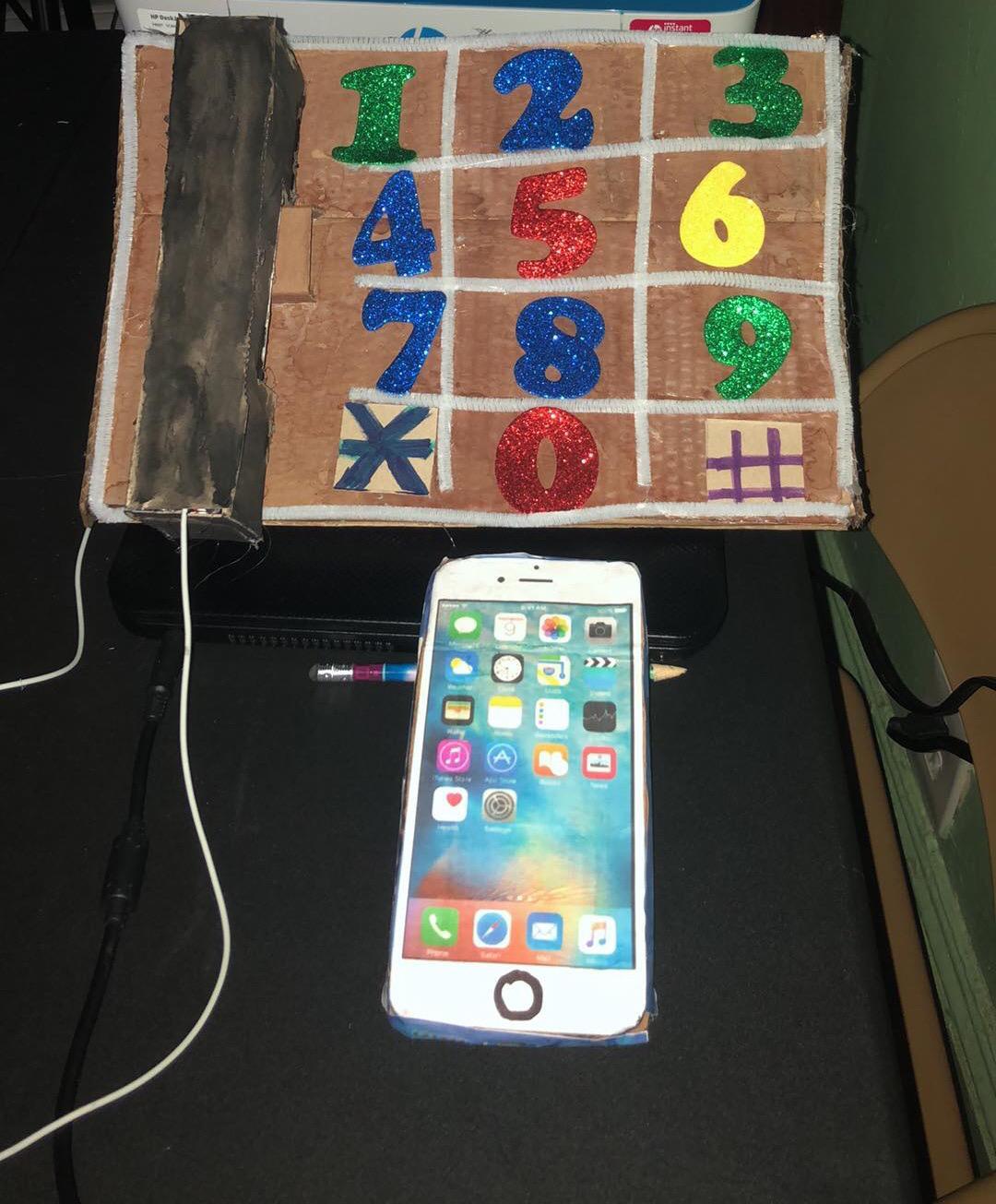 cardboard wall phone next to cell phone