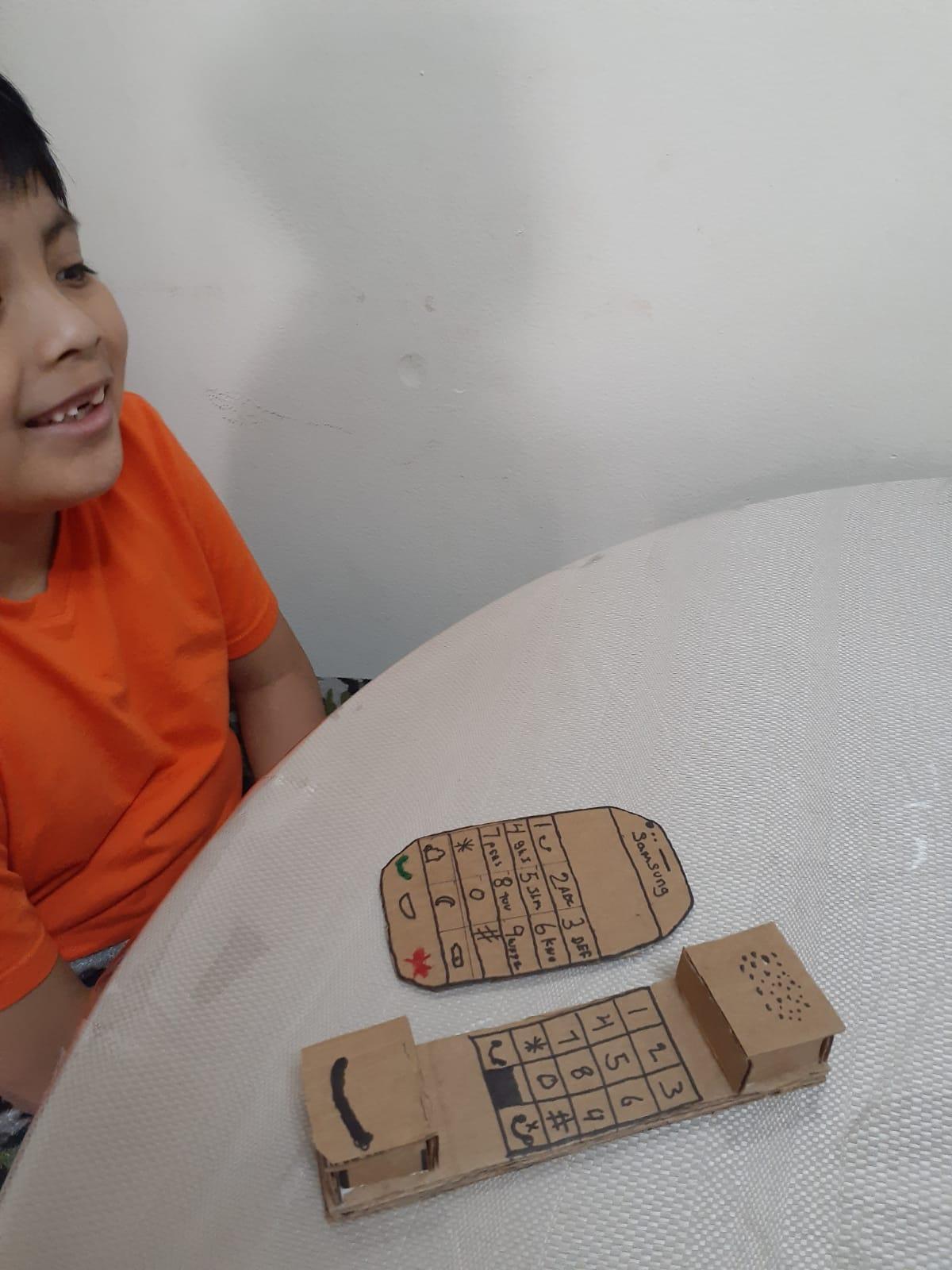 boy made a cardboard portable phone and smartphone