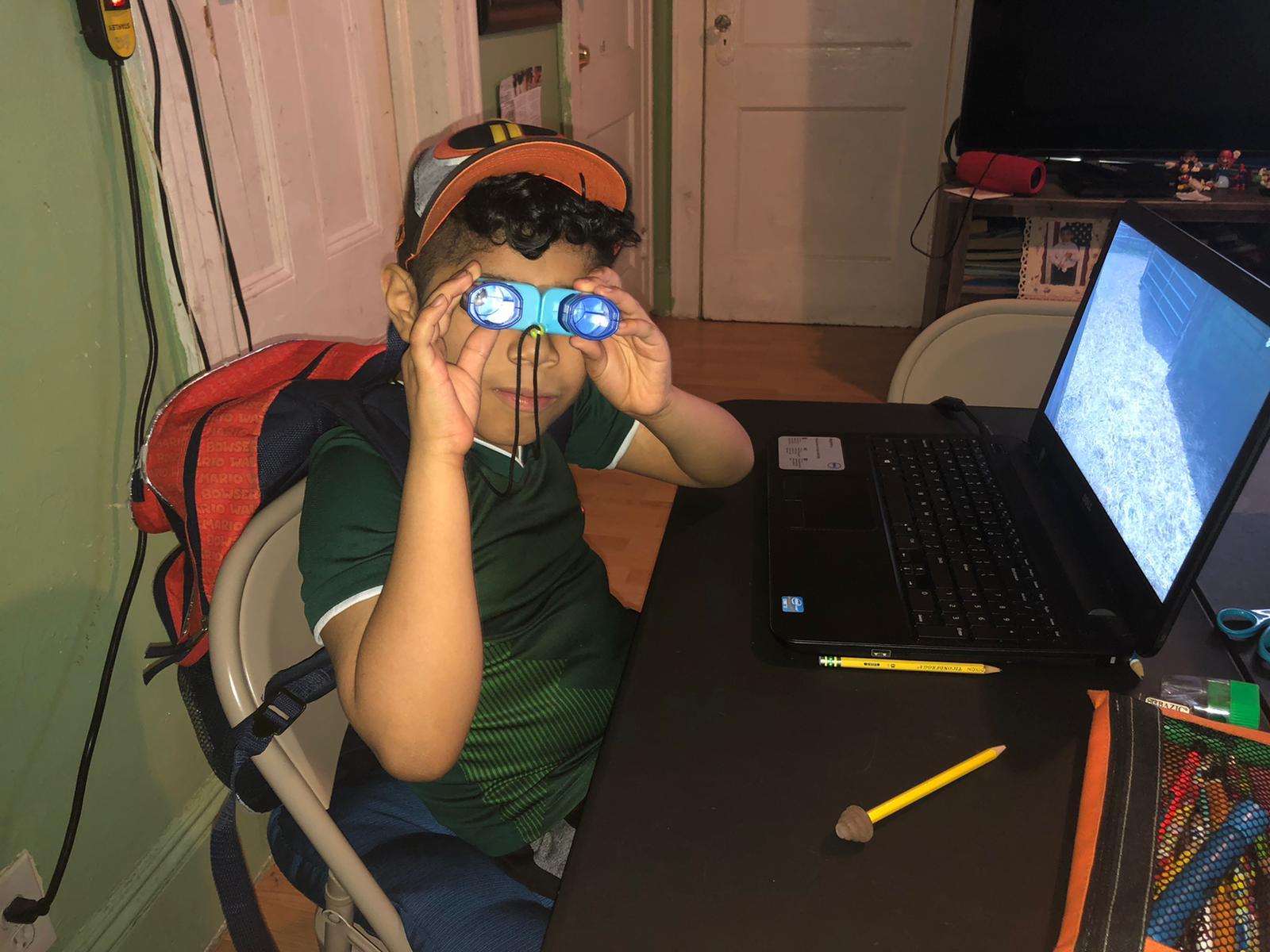 boy showing off his binoculars