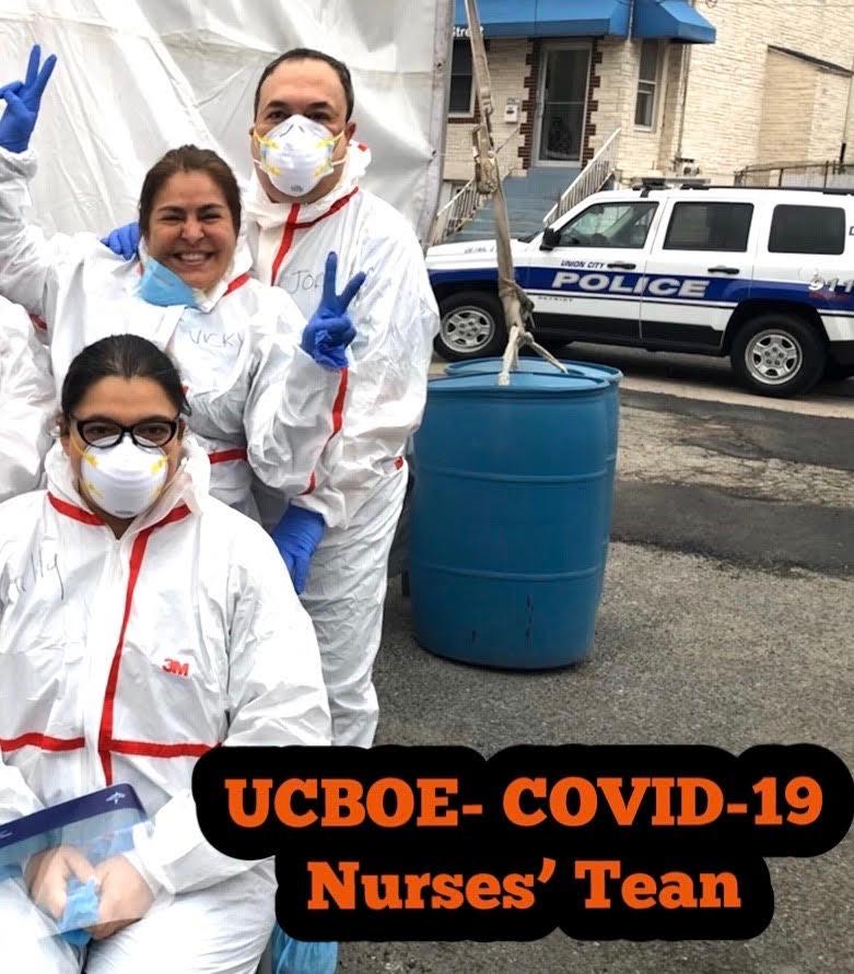 3 nurses in hazmat suits 