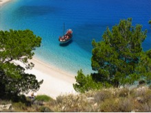 picture of a small boat at the edge of a beach